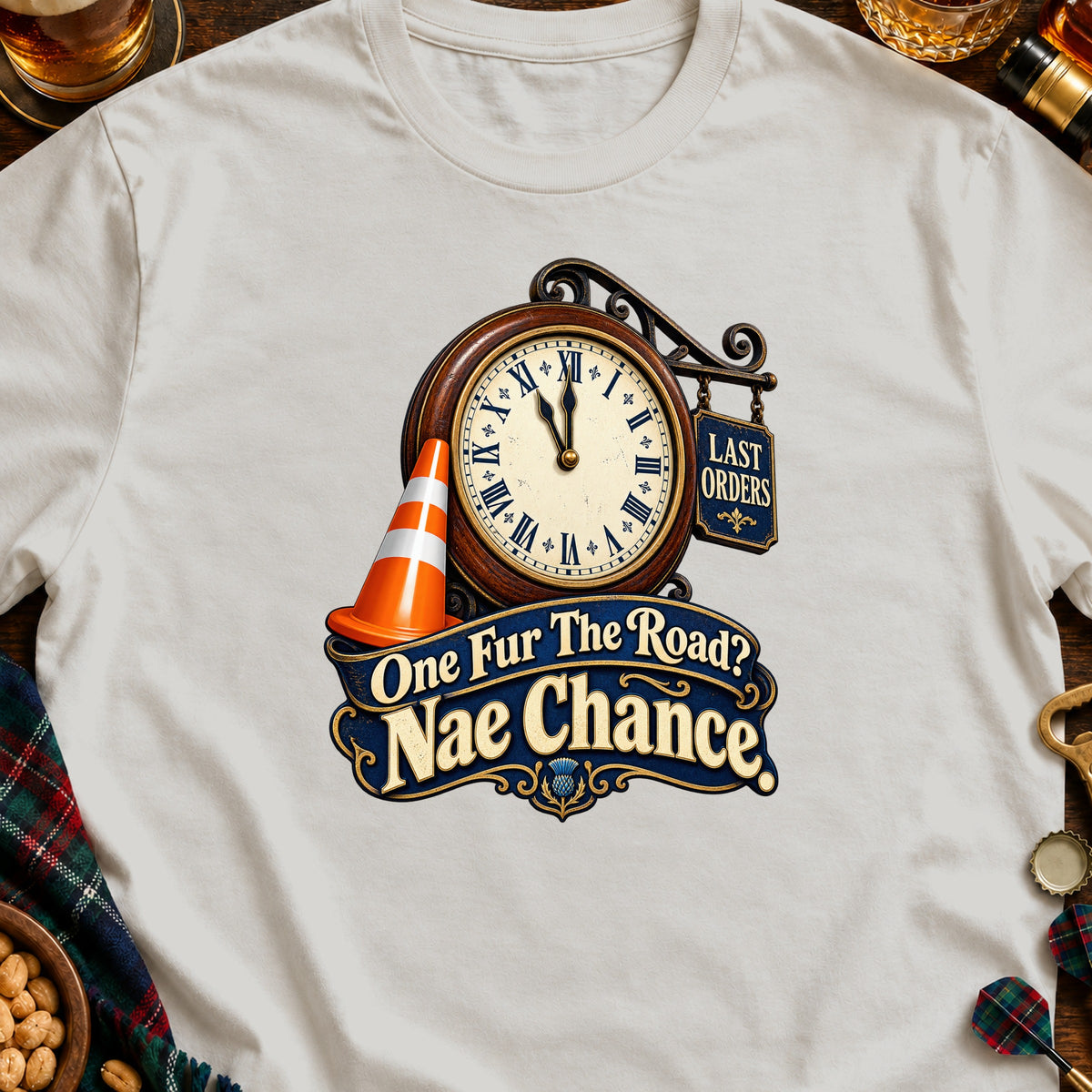 Cream t-shirt with a graphic of a clock, traffic cone, and text "Last Orders" and "One Fur The Road? Nae Chance".