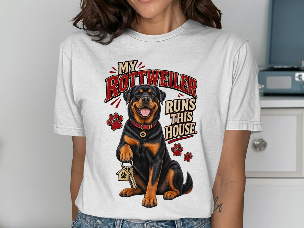 Rottweiler with keys and paw prints on a white t-shirt, text reads "MY ROTTWEILER RUNS THIS HOUSE."