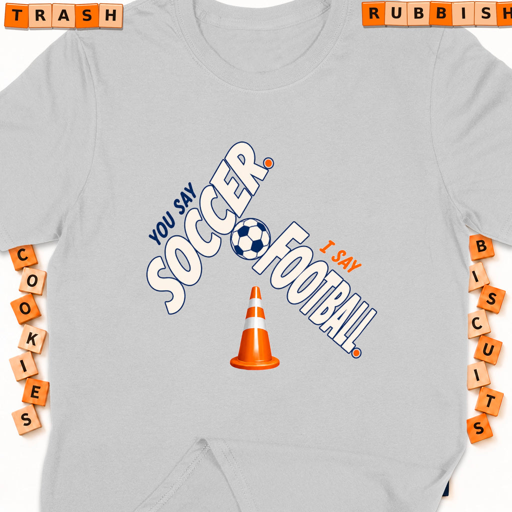 Light gray t-shirt with "You Say Soccer, I Say Football" graphic and traffic cone.