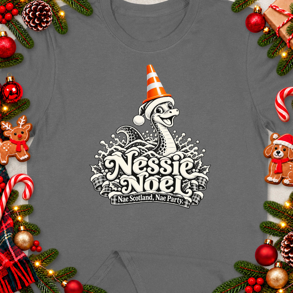 Grey t-shirt with Nessie Noel design featuring a Loch Ness Monster in festive attire and text.