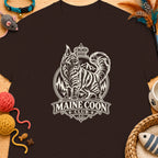 Brown t-shirt with a circular Maine Coon Club logo featuring a crowned cat and mountains.