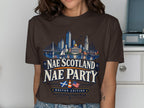 Brown t-shirt with Boston skyline graphic and "Nae Scotland Nae Party Boston Edition" text.
