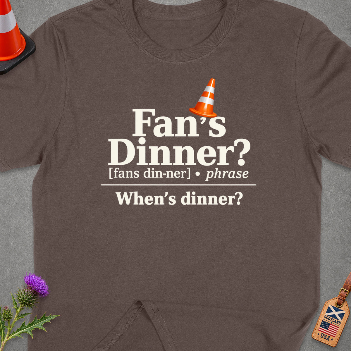 Brown t-shirt with "Fan's Dinner? When's dinner?" text and traffic cone graphic.