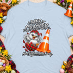 Light blue t-shirt with cartoon chick in tartan eggshell and orange traffic cone.