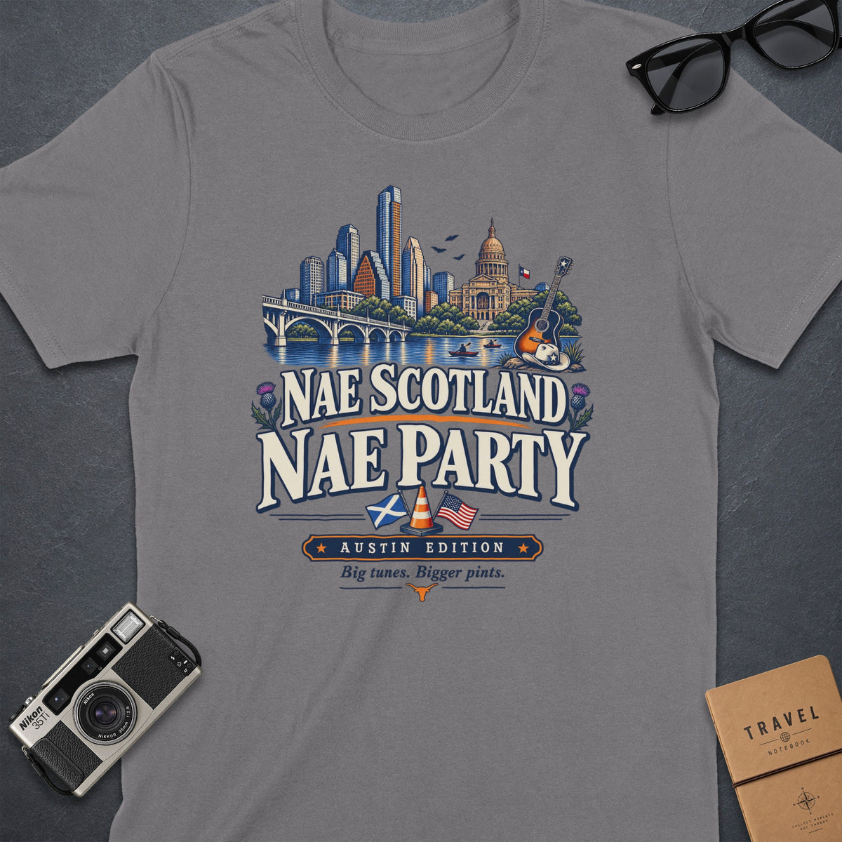 Grey t-shirt with "Nae Scotland Nae Party Austin Edition" graphic and cityscape.