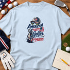 Light blue t-shirt featuring a golf-themed graphic with the text American By Birth Golfer By Bad Decision.