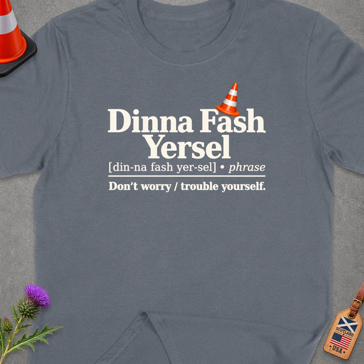 T-shirt with text "Dinna Fash Yersel" and its definition, with a traffic cone.
