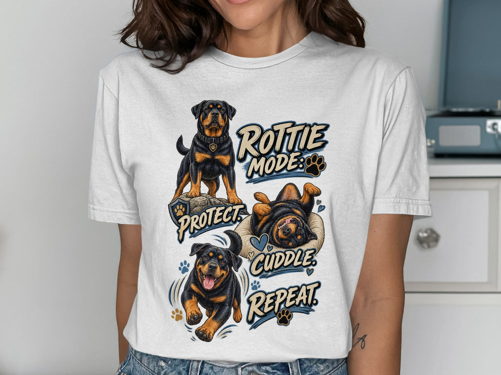 White t-shirt with Rottie Mode Protect Cuddle Repeat graphic featuring Rottweilers.