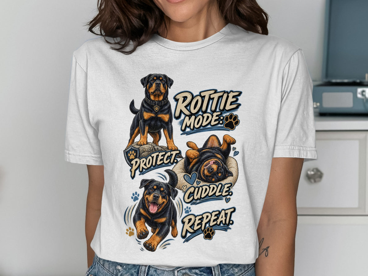White t-shirt with Rottie Mode Protect Cuddle Repeat graphic featuring Rottweilers.