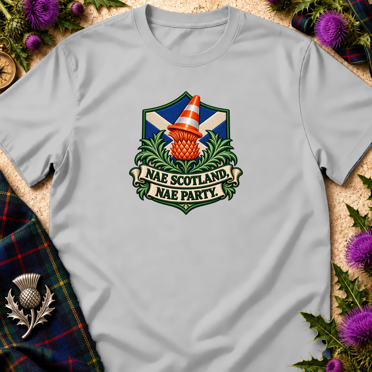 Light gray t-shirt featuring a crest with a Scottish flag, thistle, traffic cone, and text reading "NAE SCOTLAND, NAE PARTY."