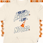 Cream t-shirt with "You Say Awesome, I Say No Bad" graphic and traffic cone.