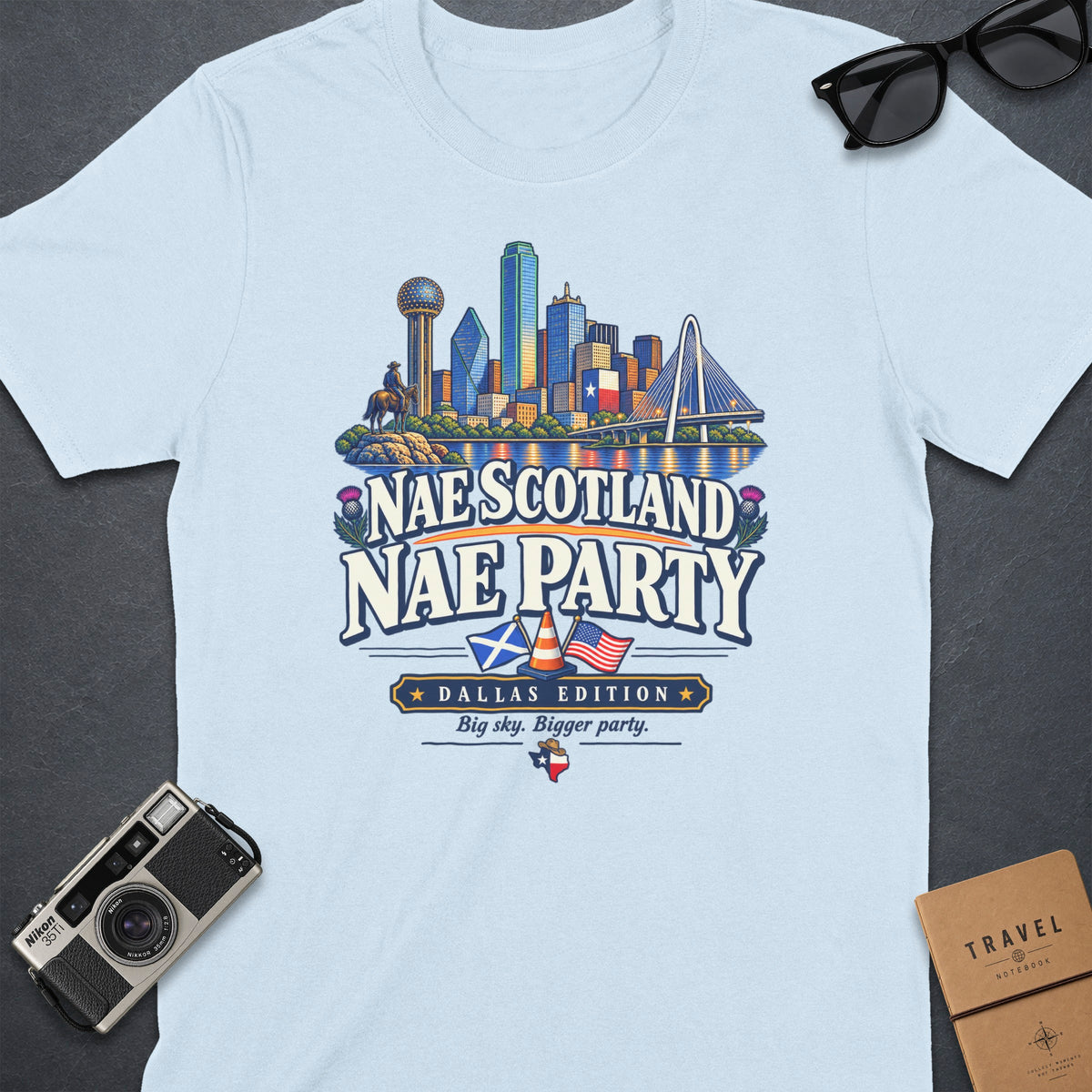 Light blue t-shirt featuring Dallas skyline graphic with text "Nae Scotland Nae Party".