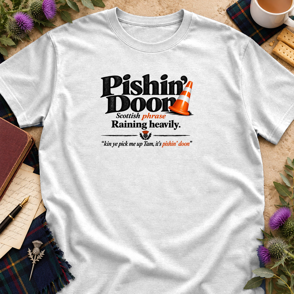 White t-shirt featuring black text reading Pishin' Doon, Scottish phrase Raining heavily, and an orange traffic cone.