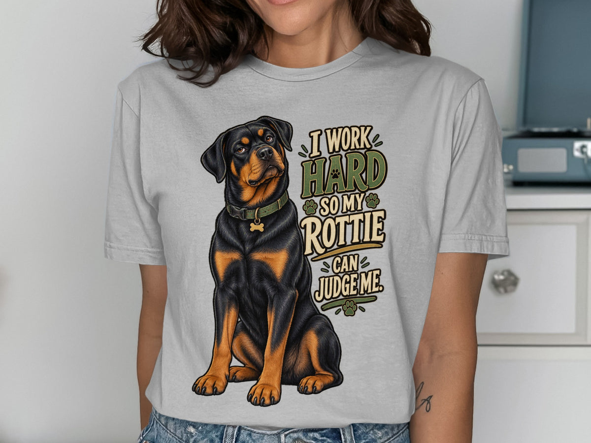 Light gray t-shirt with Rottweiler graphic and text "I Work Hard So My Rottie Can Judge Me."