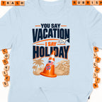 Light blue t-shirt with "You Say Vacation I Say Holiday" text and a traffic cone.