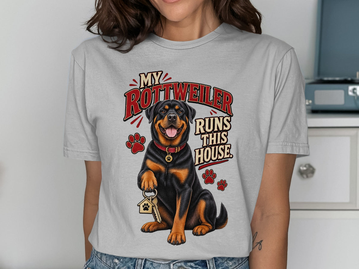 Rottweiler sitting and holding keys with text "My Rottweiler Runs This House."