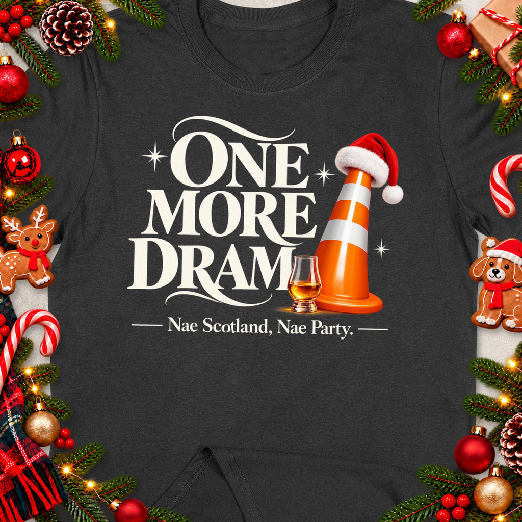 Dark t-shirt with "ONE MORE DRAM" text, traffic cone, whisky glass, and festive decorations.
