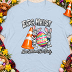 Easter bunnies carry an egg and traffic cone with text "Egg Heist Nae Scotland Nae Party."
