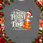 T-shirt with text "It seemed festive at the time" and a traffic cone with Santa hat.