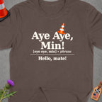 Brown t-shirt with "Aye Aye, Min! Hello, mate!" text and Scottish/USA tag.