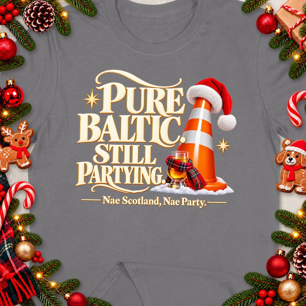 T-shirt with "Pure Baltic, Still Partying" text, Santa hat traffic cone, whisky, and festive decorations.