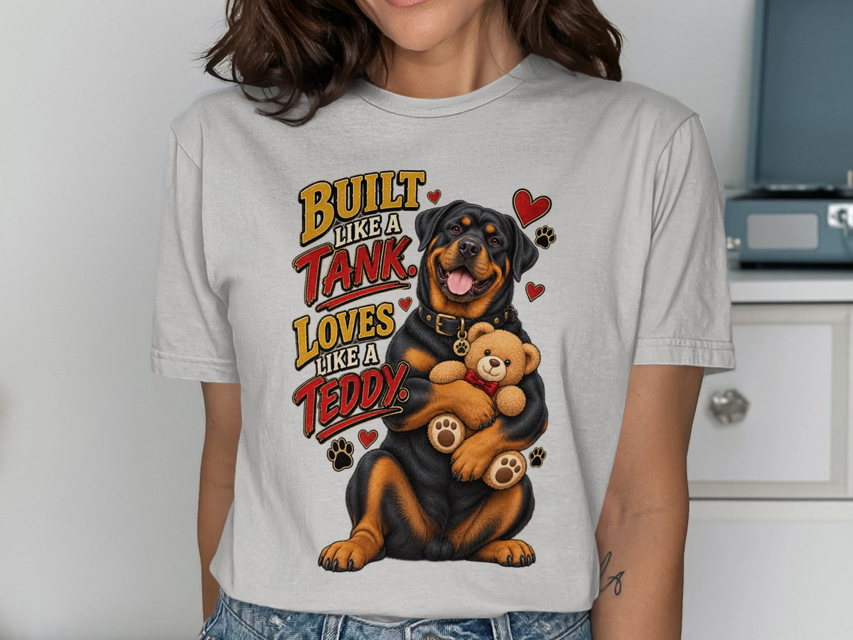 Rottweiler hugs teddy bear with text "Built like a tank, loves like a teddy".
