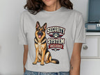 German Shepherd with "SECURITY SYSTEM INCLUDED" text on a grey t-shirt.