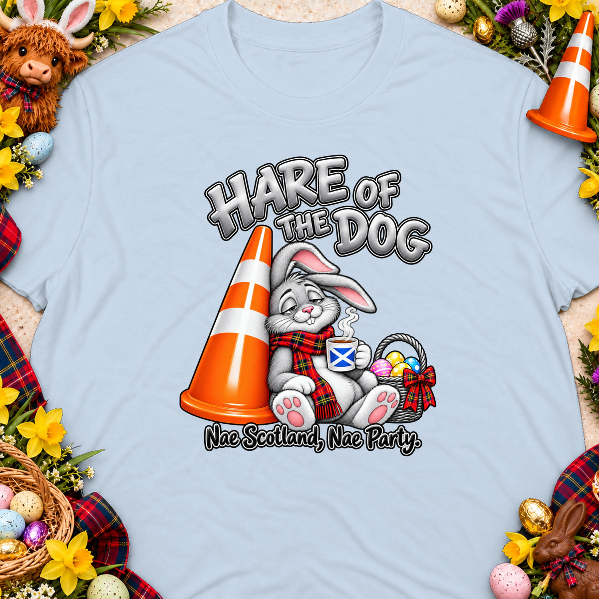 Cartoon bunny in kilt scarf holding Scottish flag mug near traffic cone and Easter eggs.