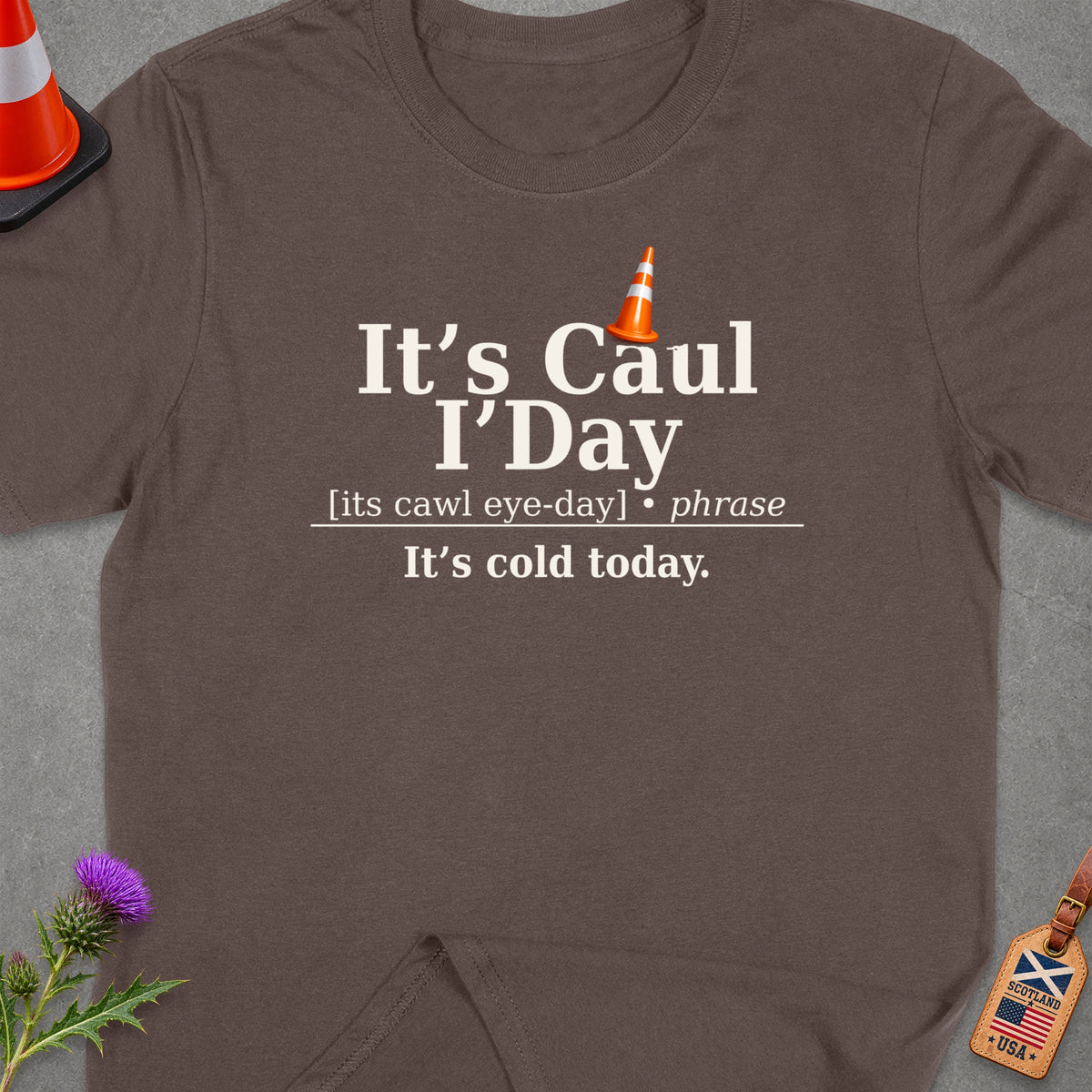 Brown t-shirt with text "It's Caul I'Day It's cold today."