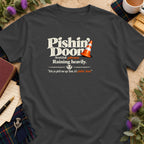 A dark gray t-shirt featuring text that reads Pishin Doon Scottish phrase Raining heavily.