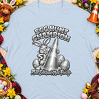 Egg Hunt Champion shirt with a cartoon bunny holding a traffic cone and festive Easter decorations.
