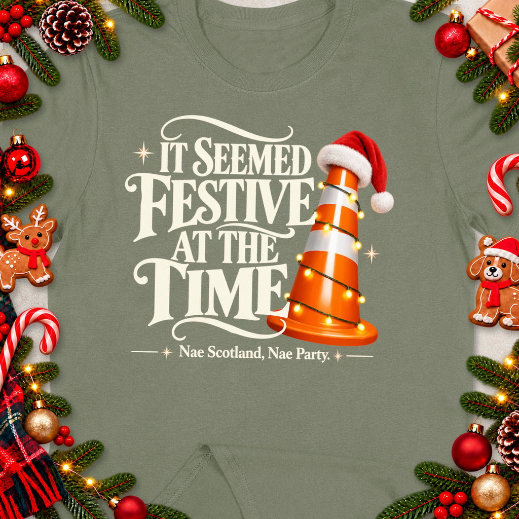 Traffic cone with Santa hat and lights, text "IT SEEMED FESTIVE AT THE TIME".