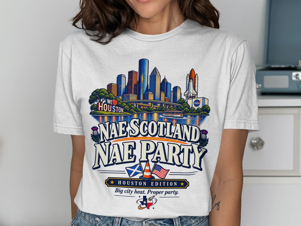 White t-shirt graphic with Houston skyline, NASA rocket, Scottish and US flags.