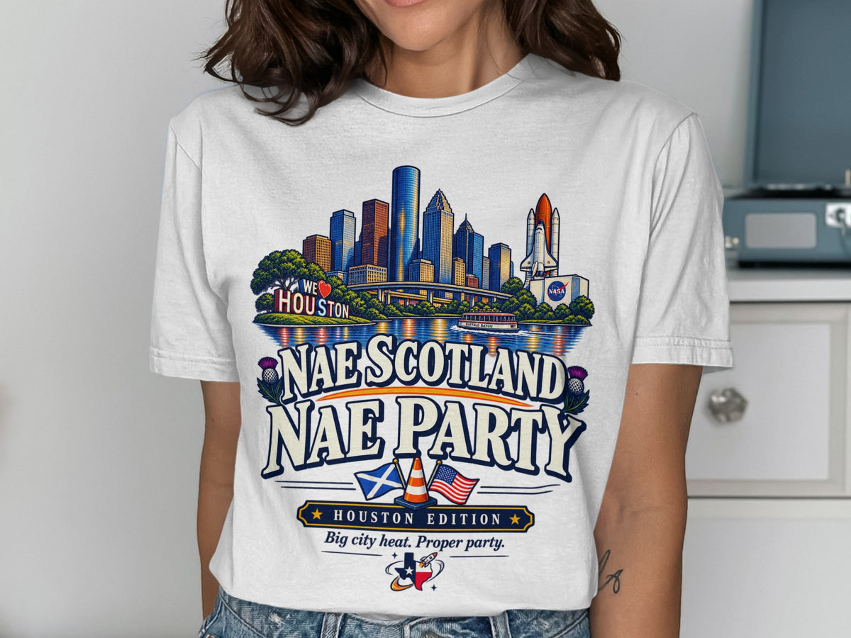 White t-shirt graphic with Houston skyline, NASA rocket, Scottish and US flags.