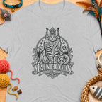 Grey t-shirt featuring a distressed graphic of a crowned Maine Coon cat, mountains, and text.