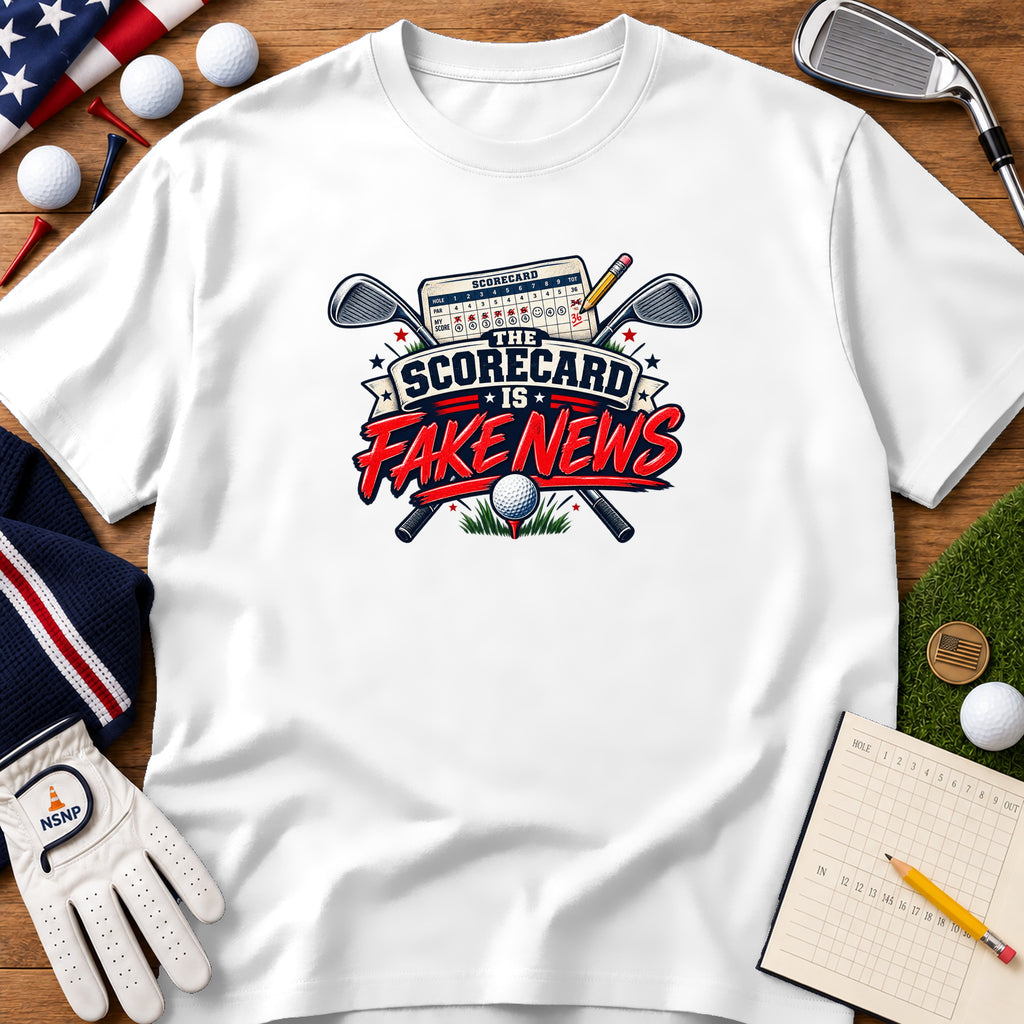 A white t-shirt featuring a graphic with crossed golf clubs, a scorecard, and the text The Scorecard is Fake News.