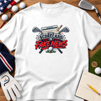 A white t-shirt featuring a graphic with crossed golf clubs, a scorecard, and the text The Scorecard is Fake News.
