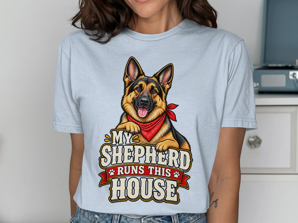 German Shepherd graphic with text "My Shepherd Runs This House" on a light blue shirt.