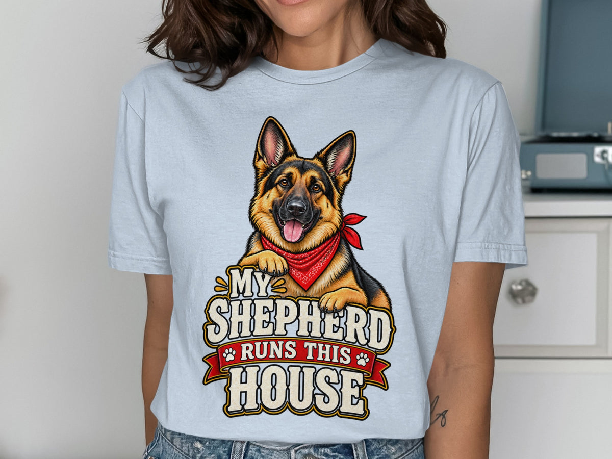 German Shepherd graphic with text "My Shepherd Runs This House" on a light blue shirt.
