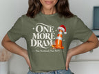 Olive green t-shirt with "One More Dram. Nae Scotland, Nae Party." text, traffic cone, Santa hat, and whiskey glass.