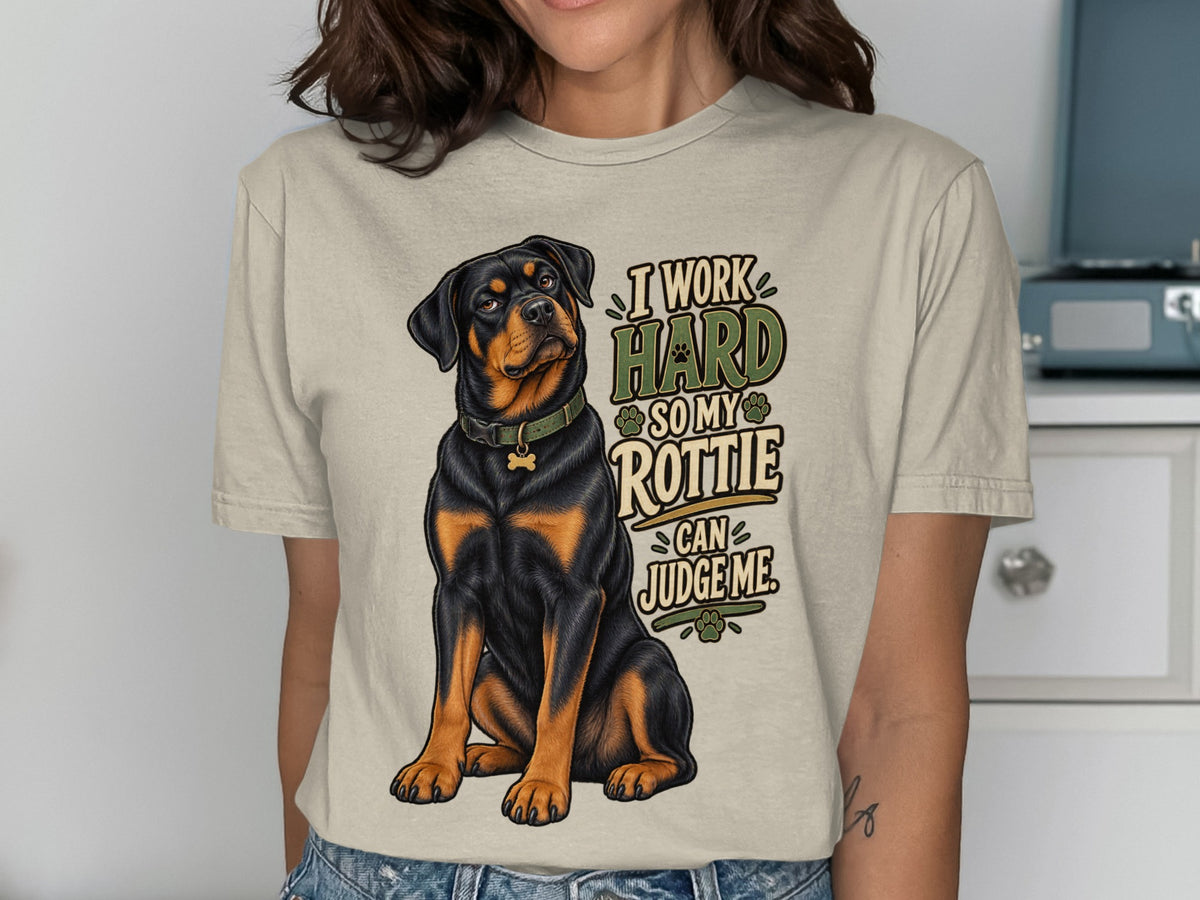 Rottweiler dog sitting with text "I work hard so my Rottie can judge me".