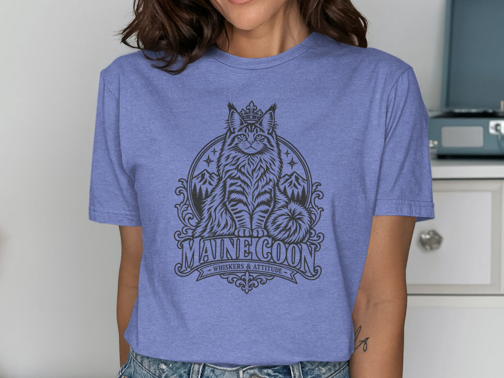 T-shirt with a black graphic of a crowned Maine Coon cat, mountains, and text.