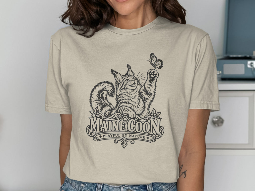 Maine Coon cat illustration with butterfly and text "MAINE COON PLAYFUL BY NATURE".