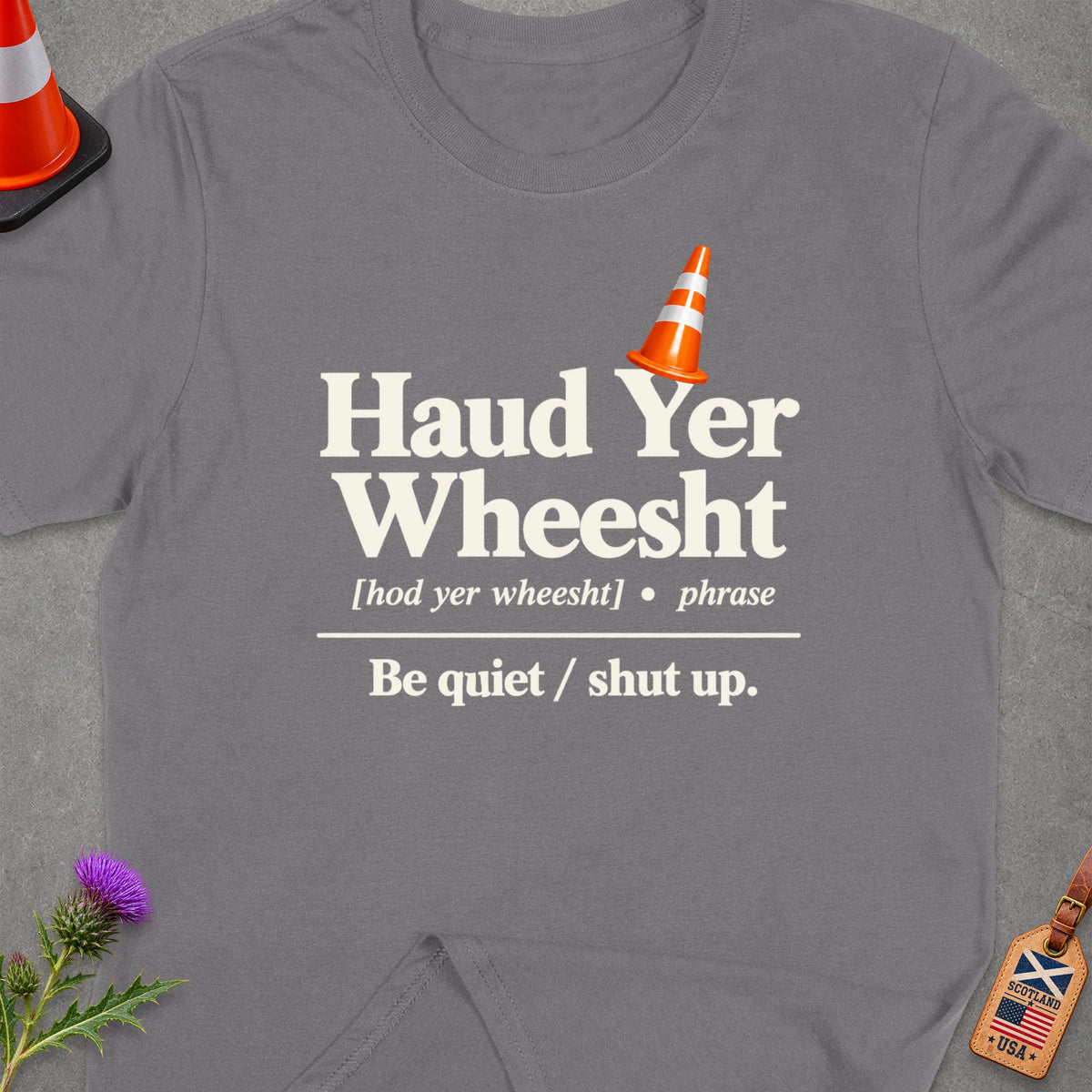 Grey t-shirt with "Haud Yer Wheesht" and definition, traffic cone, and thistle.