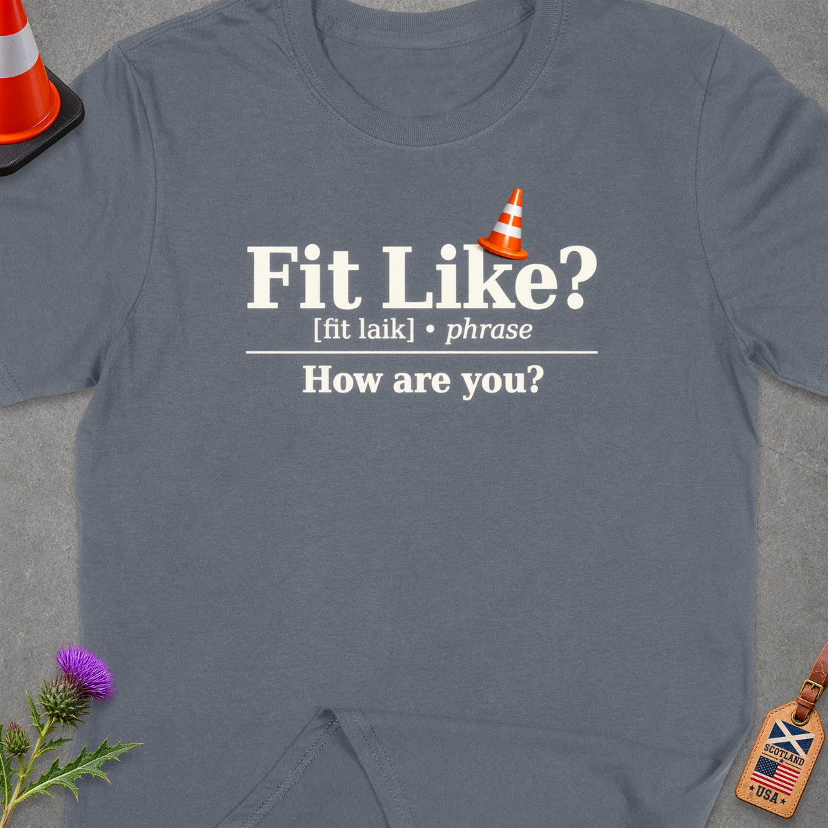 T-shirt with "Fit Like? [fit laik] • phrase How are you?" text.