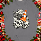 Otterly Merry graphic with otter holding traffic cone on a t-shirt.