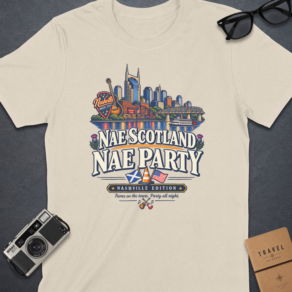 Cream t-shirt graphic with Nashville skyline, Scottish and US flags, and text "Nae Scotland Nae Party".