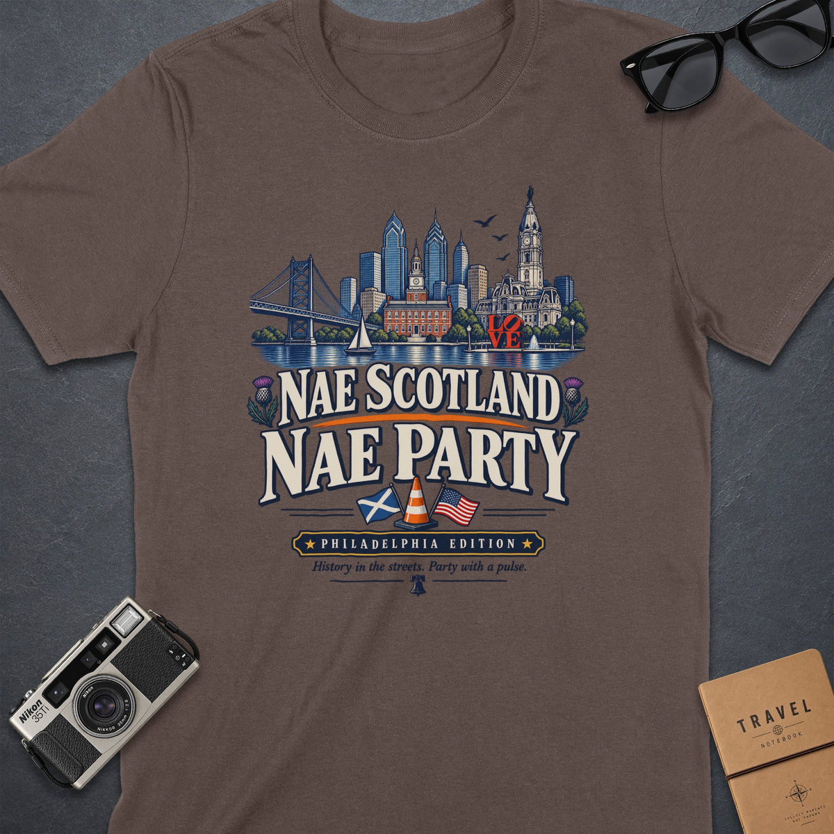 Brown t-shirt with Philadelphia skyline, "Nae Scotland Nae Party," and "Philadelphia Edition" text.