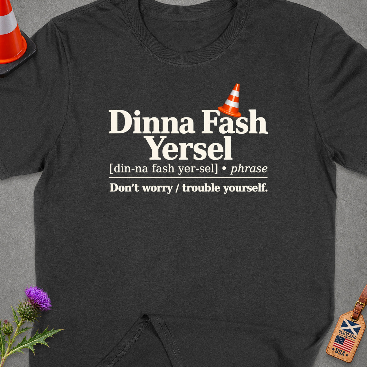 Dark grey t-shirt with "Dinna Fash Yersel" phrase and definition.