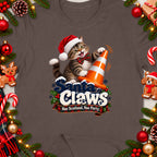 Cat in Santa hat playing with traffic cone and "Santa Claws" text.